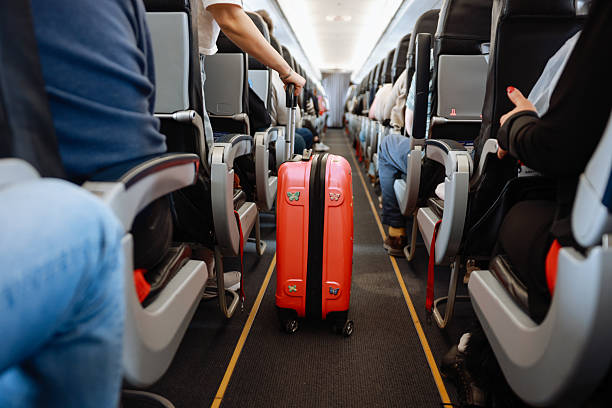 istock Interior of airplane with people sitting on seats 2208986835