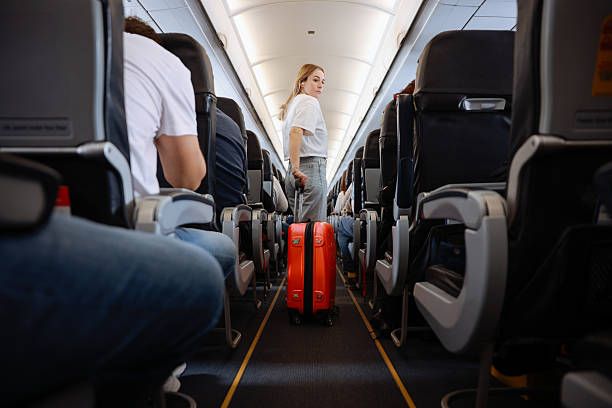 Interior of airplane with people sitting on seats