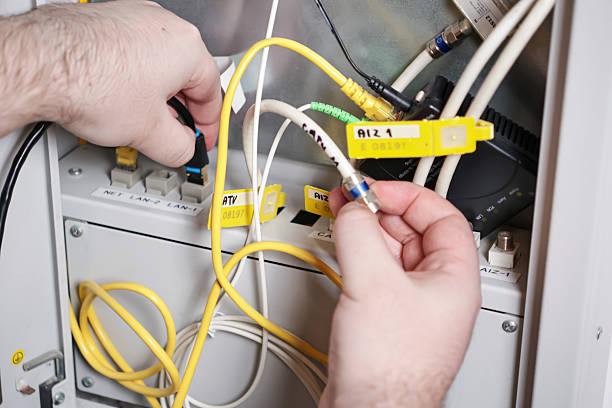 istock technician connecting network and coaxial cables in server cabinet, internet and tv installation, communication technology concept 2208987180