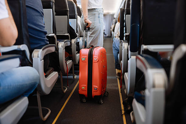 istock Interior of airplane with people sitting on seats 2208987614