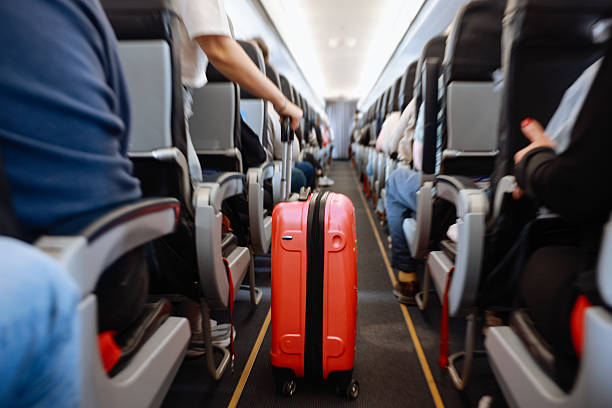 istock Interior of airplane with people sitting on seats 2208988044