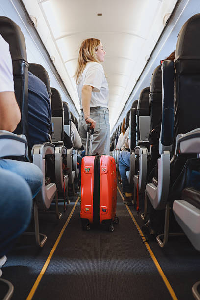 istock Interior of airplane with people sitting on seats 2208988199