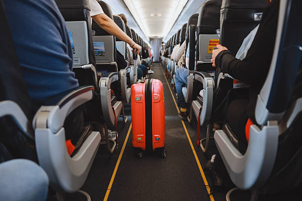 istock Interior of airplane with people sitting on seats 2208988908