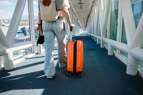 istock Young woman with cabin luggage 2208989052