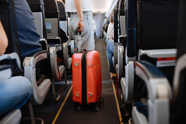 istock Interior of airplane with people sitting on seats 2208989248