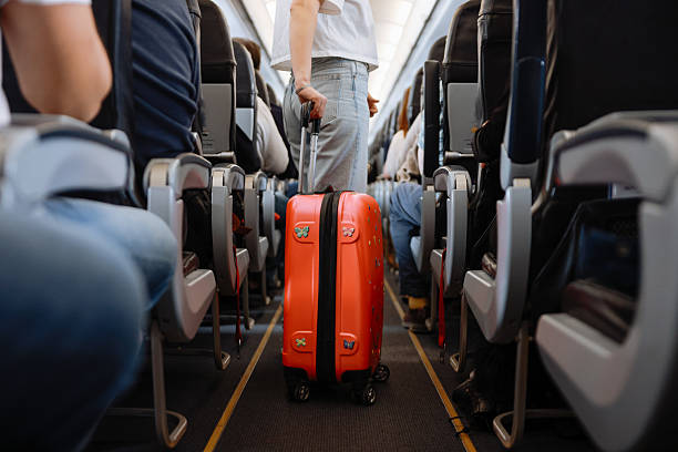 istock Interior of airplane with people sitting on seats 2208989466