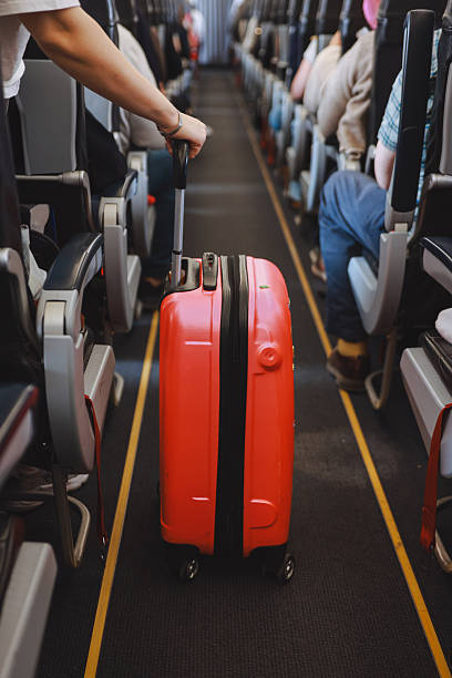 istock Interior of airplane with people sitting on seats 2208989506