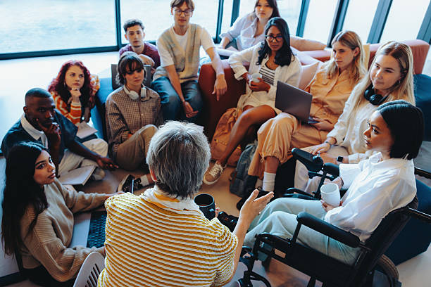 istock Diverse college group in engaging discussion with instructor, fostering inclusion and learning in a collaborative setting 2208990101