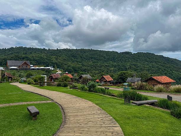 istock Rustic cabins and wooden pathway in lush hills. 2208993879
