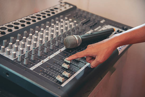 istock Production sound engineer woman hands adjusting volume equalizer voice, mixing console. DJ sound engineering working on recording studio mixing voice control.  Producer remix tune music sound record 2208994801