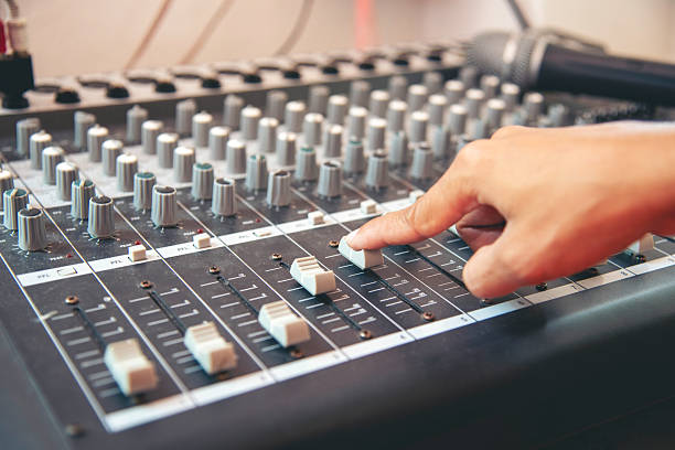istock Production sound engineer woman hands adjusting volume equalizer voice, mixing console. DJ sound engineering working on recording studio mixing voice control.  Producer remix tune music sound record 2208994826