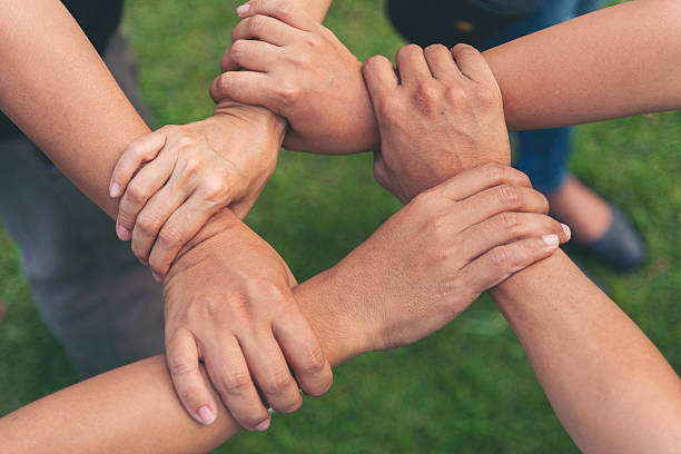 istock Diverse multiethnic Partners hands together teamwork group of multiracial people meeting join hands togetherness. Diversity people hands join empower partnership teams connection volunteer community 2208994854