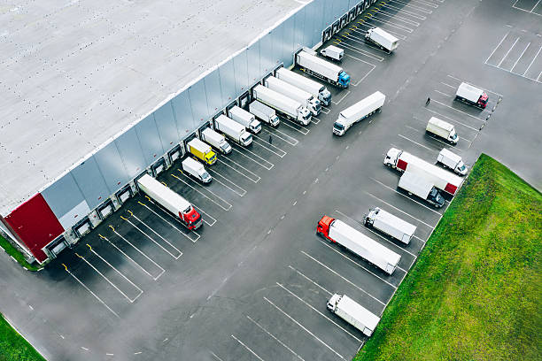 istock Aerial view of different logistic trucks at the loading docks of a large distribution warehouse. Drone photo. 2208997162