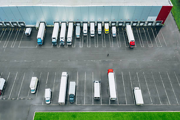 istock Aerial view of different logistic trucks at the loading docks of a large distribution warehouse 2208997213