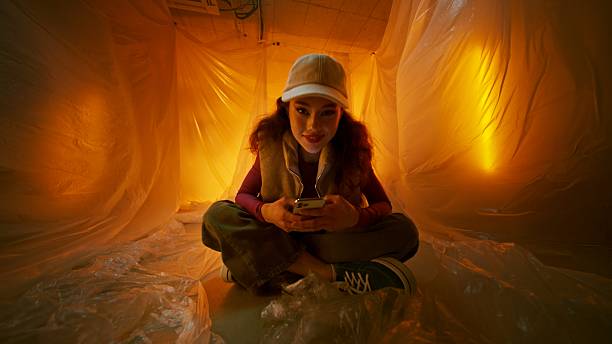istock A young girl is engaged in using her smartphone in a cozy and ambient space 2208998220