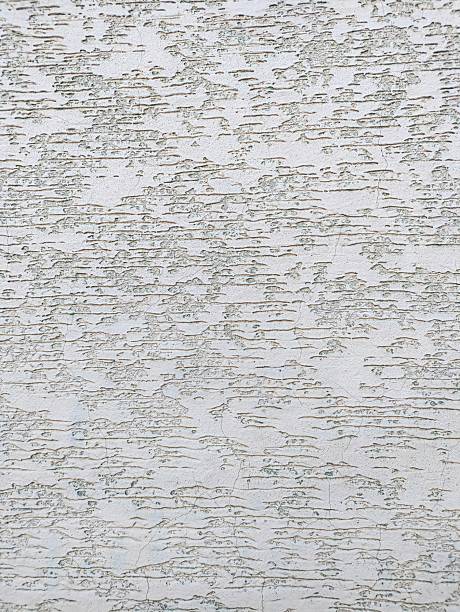 Light plaster with shallow structures, smooth in places and with horizontal lines. The texture and grain of the material and surface are clearly visible.
