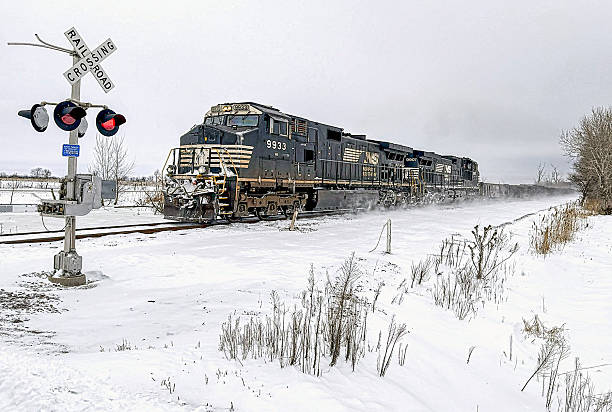Mt. Olive, IL:  A Norfolk Southern (NS) freight train makes a picturesque winter landscape as it kicks up snow while approaching a crossing in rural central Illinois.