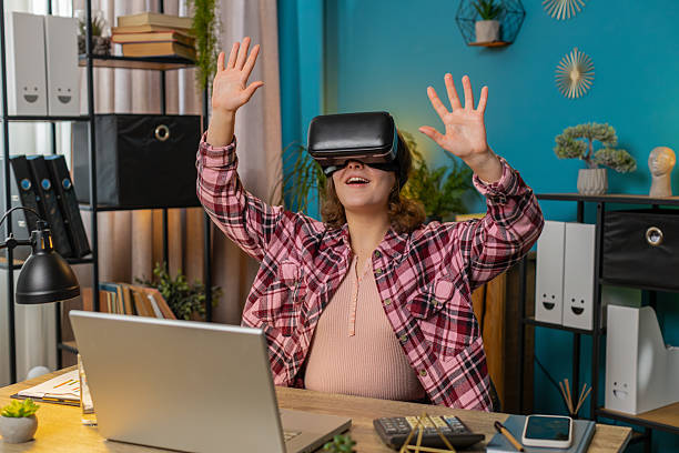 istock Business woman using virtual reality online VR app headset to simulation 3D at home office workplace 2209005462