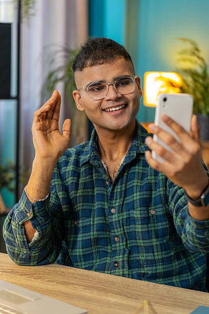 istock Happy Indian man taking selfie on smartphone communicating video call home online with subscribers 2209005576