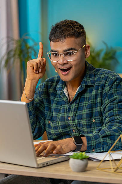 istock Inspired happy man make Eureka gesture raises finger came up with creative plan working on laptop 2209005603