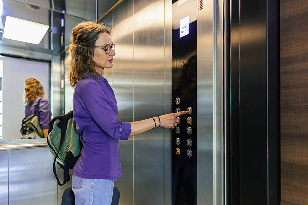 istock Confident business woman use elevator to reach her office 2209005823
