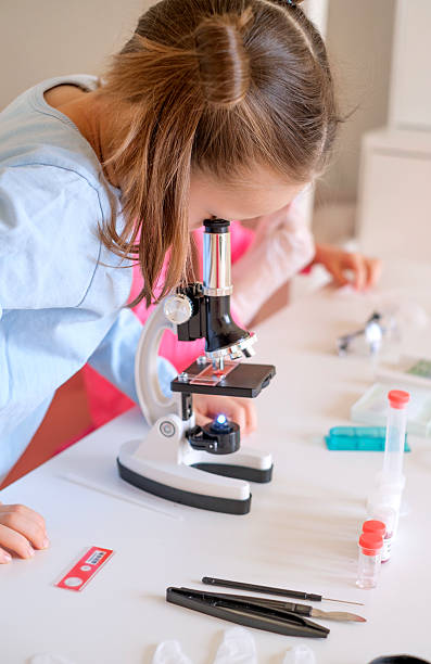 istock A child examines bacteria under an optical microscope. Scientific research in biology class 2209007789