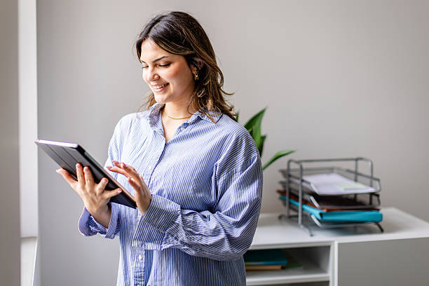 istock Young business professional engaged with technology in a contemporary office setting 2209009694