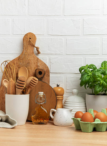 istock Kitchen utensils, eggs, and basil creating a rustic culinary scene on wooden countertop 2209010316