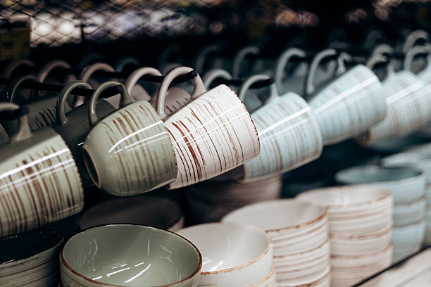 istock Shelf with ceramic cups and plates for sell in a tableware store. 2209014333