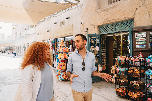 istock Tourists walking and talking in the Old Souk in Dubai 2209014706