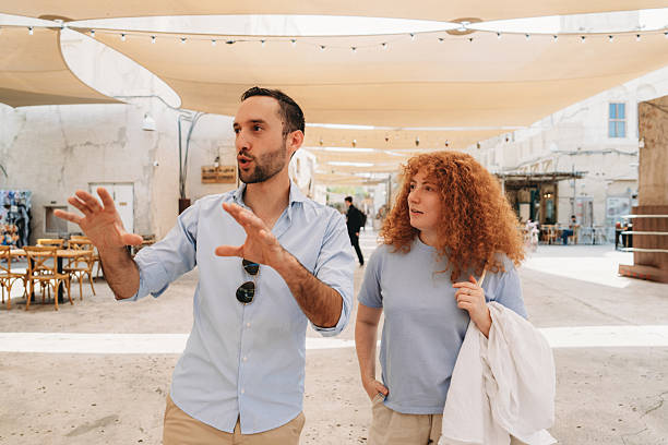 istock Tourist guide explaining something to a tourist in Old Dubai 2209014726