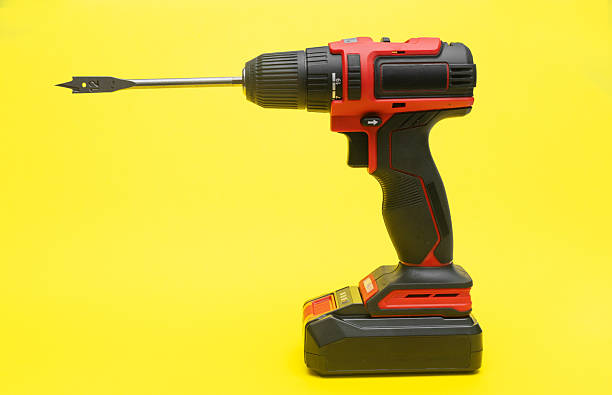 istock a cordless screwdriver. on a yellow background. 2209016232