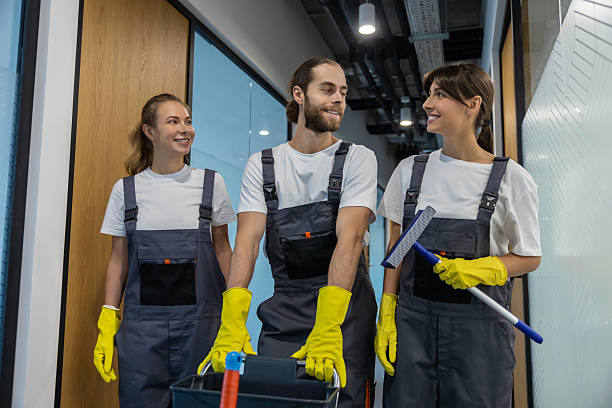 istock Group of young people in uniform going to clean the office 2209017022