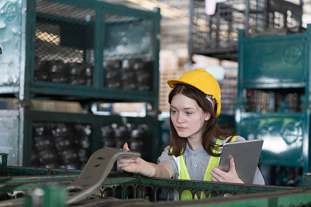 istock Distribution warehouse, Woman worker, Female worker wearing safety uniform working with digital tablet and inspecting quality for auto spare parts at warehouse 2209017576