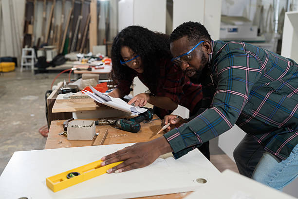 istock Plywood processing plant. Furniture manufacturing. Two worker working together, using carpenter tools in furniture factory. Unity and teamwork concept 2209018208