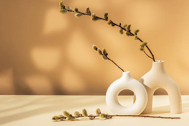 istock Two modern ceramic vases with willow flowers. Spring bright background. 2209018511