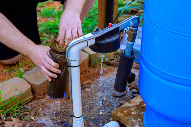 istock Hands collecting water from a rainwater harvesting system in a backyard setup in the afternoon sun 2209021344