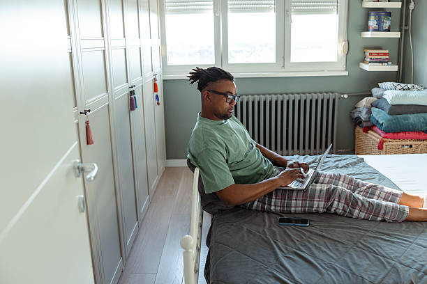 istock Man working on a laptop from home in a relaxed environment 2209021603
