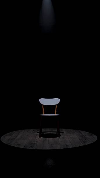 istock Minimalistic Wooden Chair Under Single Spotlight on Stage 2209024160