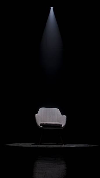 istock Modern Chair in Dark Room with Spotlight Illumination 2209024315