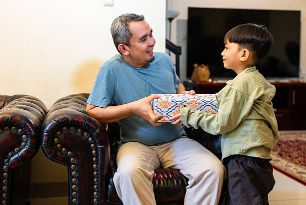 istock I have the best dad ever. Son surprising his father with birthday present 2209026889