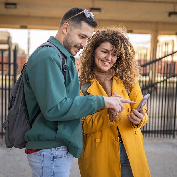 istock young couple use mobile phone for research while wait train on station 2209027516