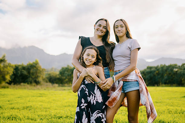 istock Mother Embraces Daughters on Kauai Hawaii 2209027870