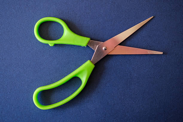 istock Small Medical Scissors Against Blue Background 2209029127