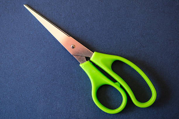 istock Small Medical Scissors Against Blue Background 2209029129