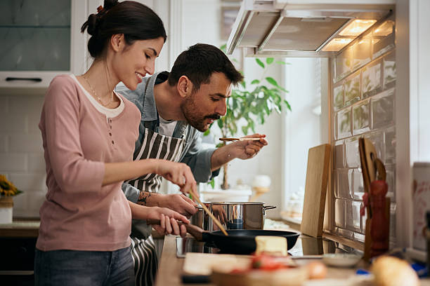 istock Happy couple cooking together in the kitchen. 2209029164