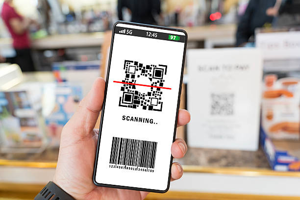 istock Id qr. Hand holding mobile smartphone screen for online pay, scan barcode technology with qr code scanner 2209030145