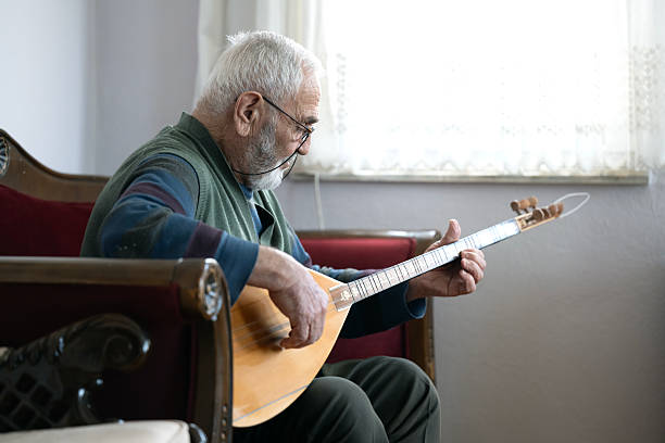 istock An elderly man performing turkish string instrument baglama 2209034296