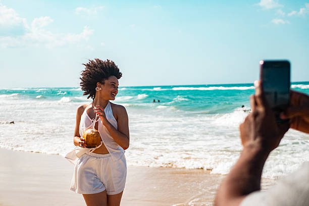 Young boyfriend posing to photo on the beach