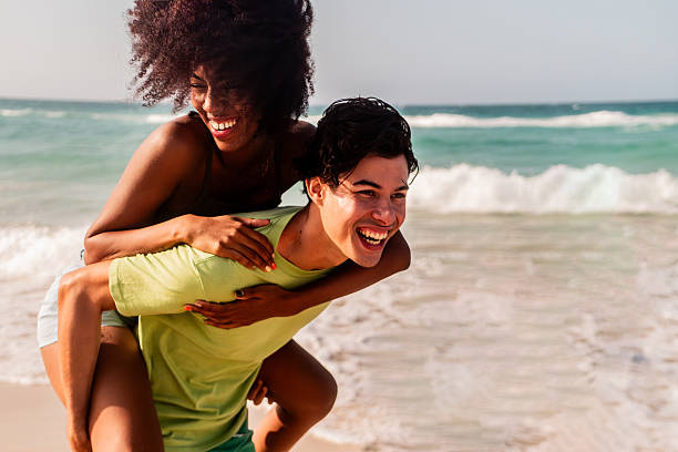 istock Happy young couple playing on the beach 2209036002